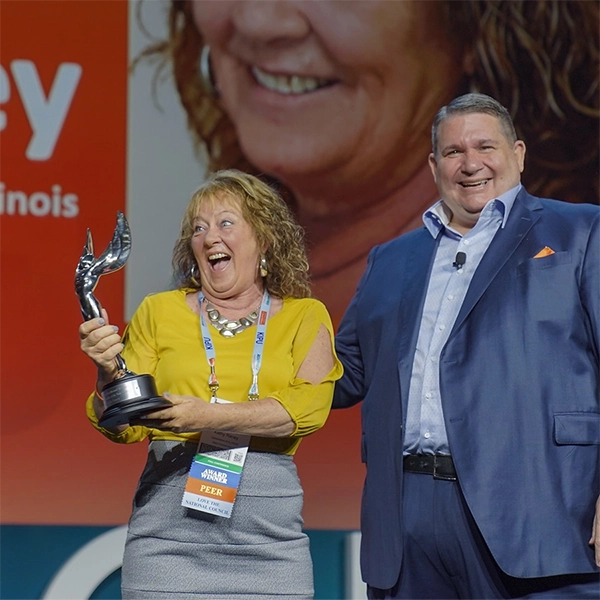 Kathy Raney accepting award at NatCon22