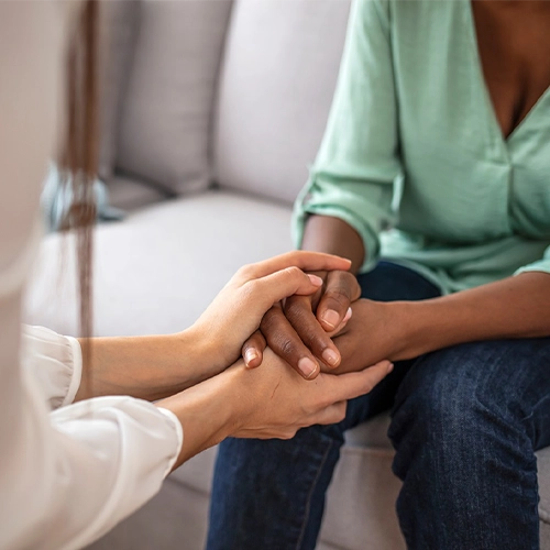 a counselor clutching their patients hand