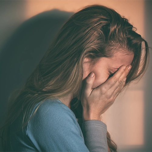 A Teen With Her Head in Her Hands