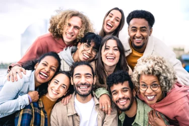 smiling young people huddling together