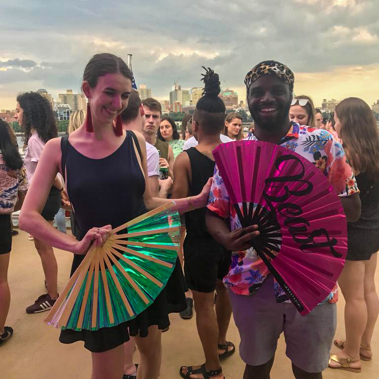 Caroline Davidson smiling with friends at an LGBTQ+ event