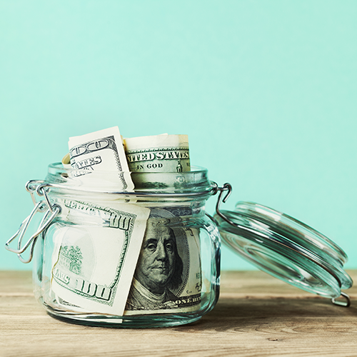 small jar filled with hundred-dollar bills