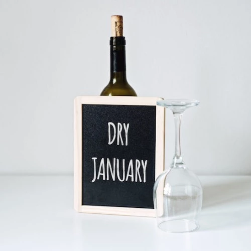 wine bottle behind chalkboard with dry january written on it
