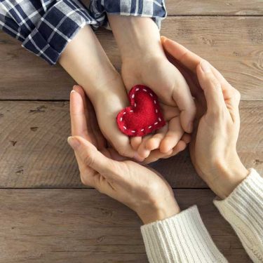 donate ad hands holding heart