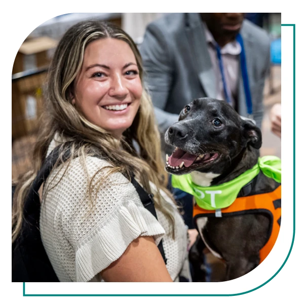 natcon attendee holds a puppy and smiles