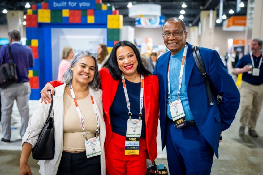 three natcon community attendees smile for a phtoo