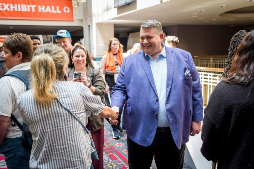 national council ceo chuck ingolgia shakes a colleague's hand at natcon
