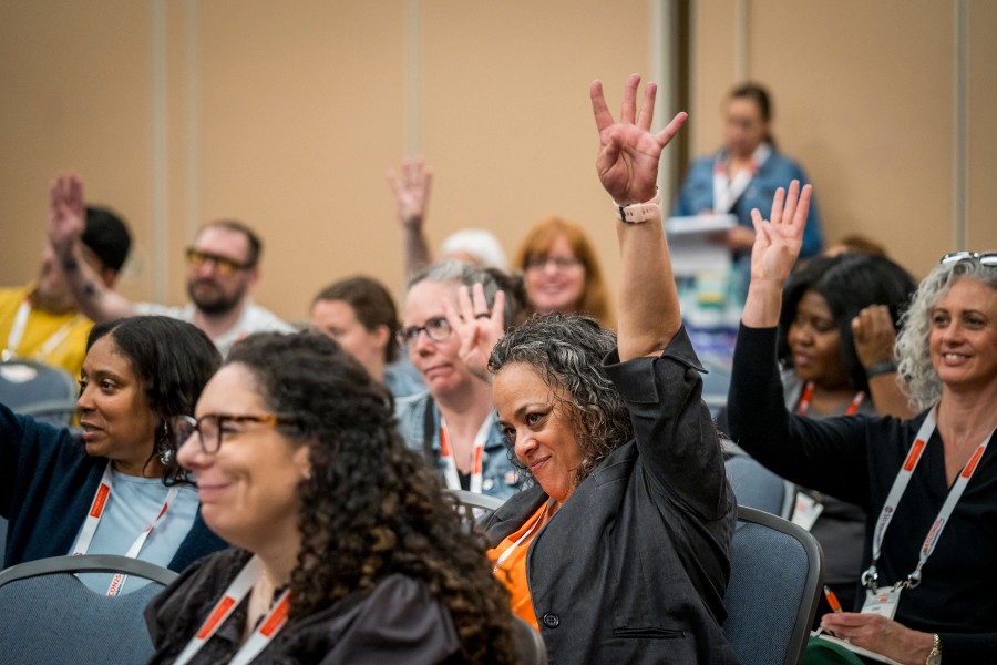 attendees raise their hands during a natcon learning track session