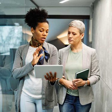 Women_discussing_office_shutterstock_212991572322