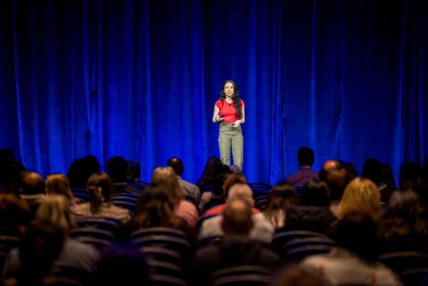 a presenter on stage at NatCon 2026