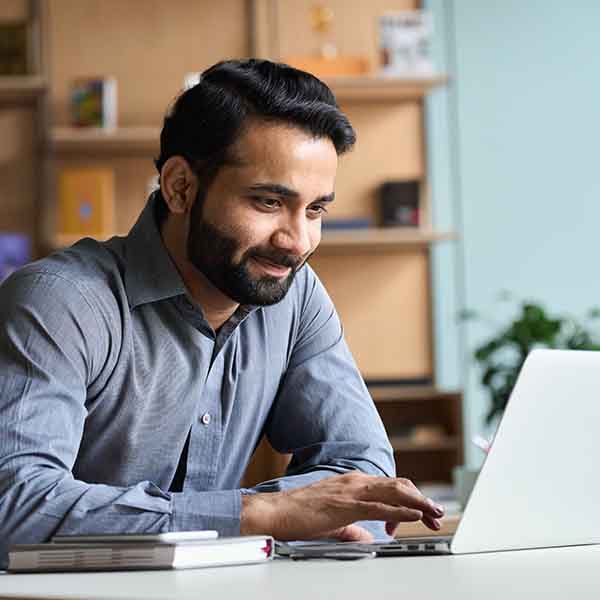a man works on a computer in an office